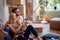 Young couple taking selfie  in new apartment, sitting on a floor.  new apartment, new beginning, joy, carefree,  concept