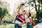 Young couple taking selfie photo while riding electric scooters