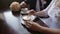 Young couple talking and drinking coffee during breakfast at cafe. They mixing sugar in cappuccino.