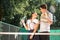 Young couple on tennis court.