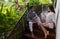 Young Couple On Terrace Tropical Hotel, Man And Woman Tropic Holiday Vacation