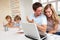 Young couple thinking and looking at a laptop