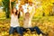 Young couple throwing autumn leaves