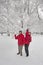 Young couple throwing snowballs