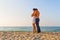 Young couple tightly embraced at the beach