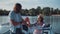 Young couple toasting each other in a motorboat