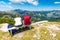Young couple on top of mountain is looking to far hill. Slovenia mountain Vogel, Triglav and near Bohinj lake