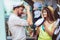 Young couple of tourists buying Captain`s cap in gift street stall outdoor