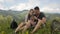 Young couple of tourists doing selfie in the mountains