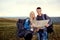 A young couple of tourists with a map in a hike in nature