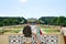 Young couple tourists view gardens leading to Neptune Fountai