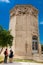 Young couple of tourists visiting the Tower of the Winds or the Horologion of Andronikos Kyrrhestes