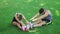 Young couple training stretch exercises together in summer park