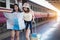 Young couple traveler with map at train station. Asian girls lost at railway in summer on vacation. women lifestyle adventure