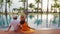 Young couple traveler relaxing and enjoying the sunset by a tropical resort pool while traveling for summer vacation