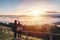 Young couple travelers looking at the sunrise and the sea of mist on the mountain in the morning, Travel lifestyle concept