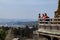 Young couple of travellers looking at city and landscape while t