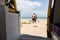 Young couple travelling by campervan along the seaside and chilling out at the beach