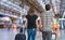 Young couple is travelling on vacation. Man and woman with baggage in train station