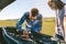 Young couple tries to fix the broken down car