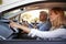 Young couple on a trip in a car navigating with a smartphone