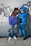 Young couple urban fashion standing portrait wall