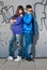 Young couple urban fashion standing portrait wall