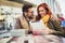 Young couple using a digital tablet together at a coffee shop