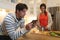 Young couple using tablet computer while cooking