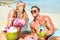 Young couple vacationers drinking cocunut cocktail and having fun on tropical beach in Phuket Thailand - Luxury travel concept