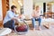 Young couple with vacuum cleaner in the living room