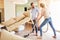 Young couple vacuuming in the living room