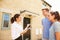 Young couple viewing a house with female real estate agent