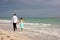 Young couple walking along bonita beach as sunsets