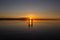 Young couple is walking away in the water on summer beach. Sunset over the sea.Two silhouettes against the sun. Just married