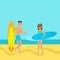 Young couple walking on the beach with surfboards