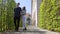 A young couple walking among decorative trees holding hands