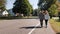 Young couple walking down the street holding hands. Typical American city