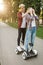 Young couple walking on gyro board in summer park