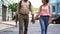 Young couple walking holding hands, newlyweds vacation, active leisure, tourism