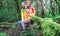 Young couple walking inside rainy forest - Hiker people having fun in to the woods - Travel, discovery, trekking, vacation and