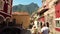 Young couple walking and a man kissing woman hand In old town main street Italy