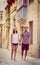 Young couple walking in old street in Valletta, Malta