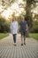 young couple walking in park trail. looking straight ahead