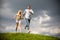 Young couple walking through summer lawn