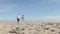 Young couple walking and talking together on the beach