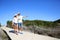 Young couple walking on a wooden pontoon