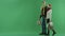 Young couple walks in front of the camera with shopping bags, chroma key on background