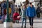 A young couple walks past a clothing store on the central promenade of Riva degli Schiavoni Slavic on a winter sunny day