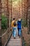 A young couple walks in the woods with a little boy